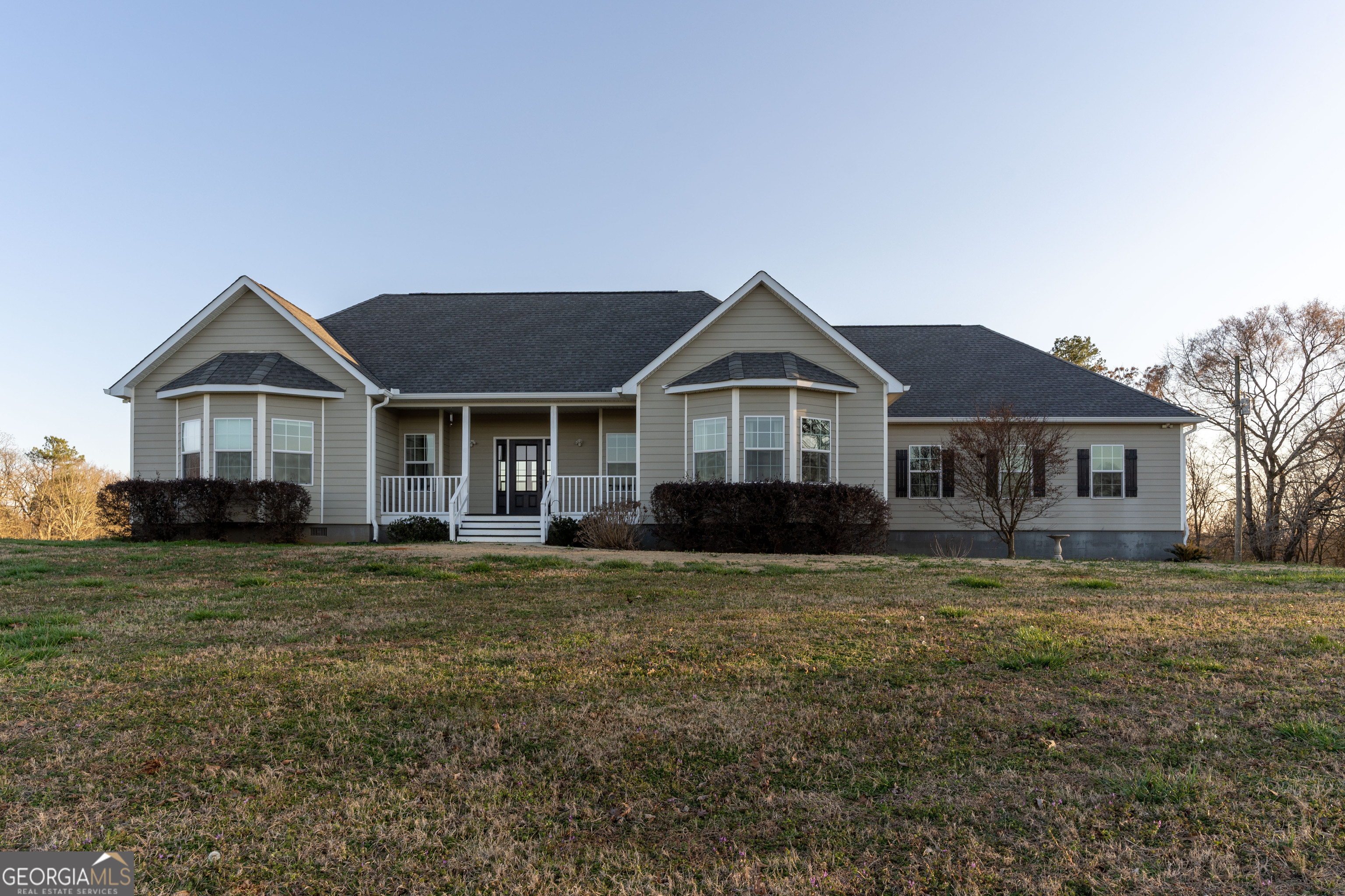 272 Harmony Road Eatonton, GA 31024 - Photo 1 of 1 a front view of a house with a yard