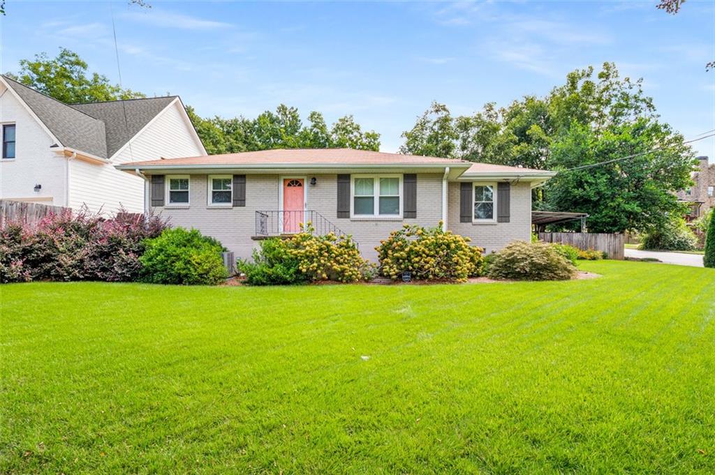a front view of a house with a garden