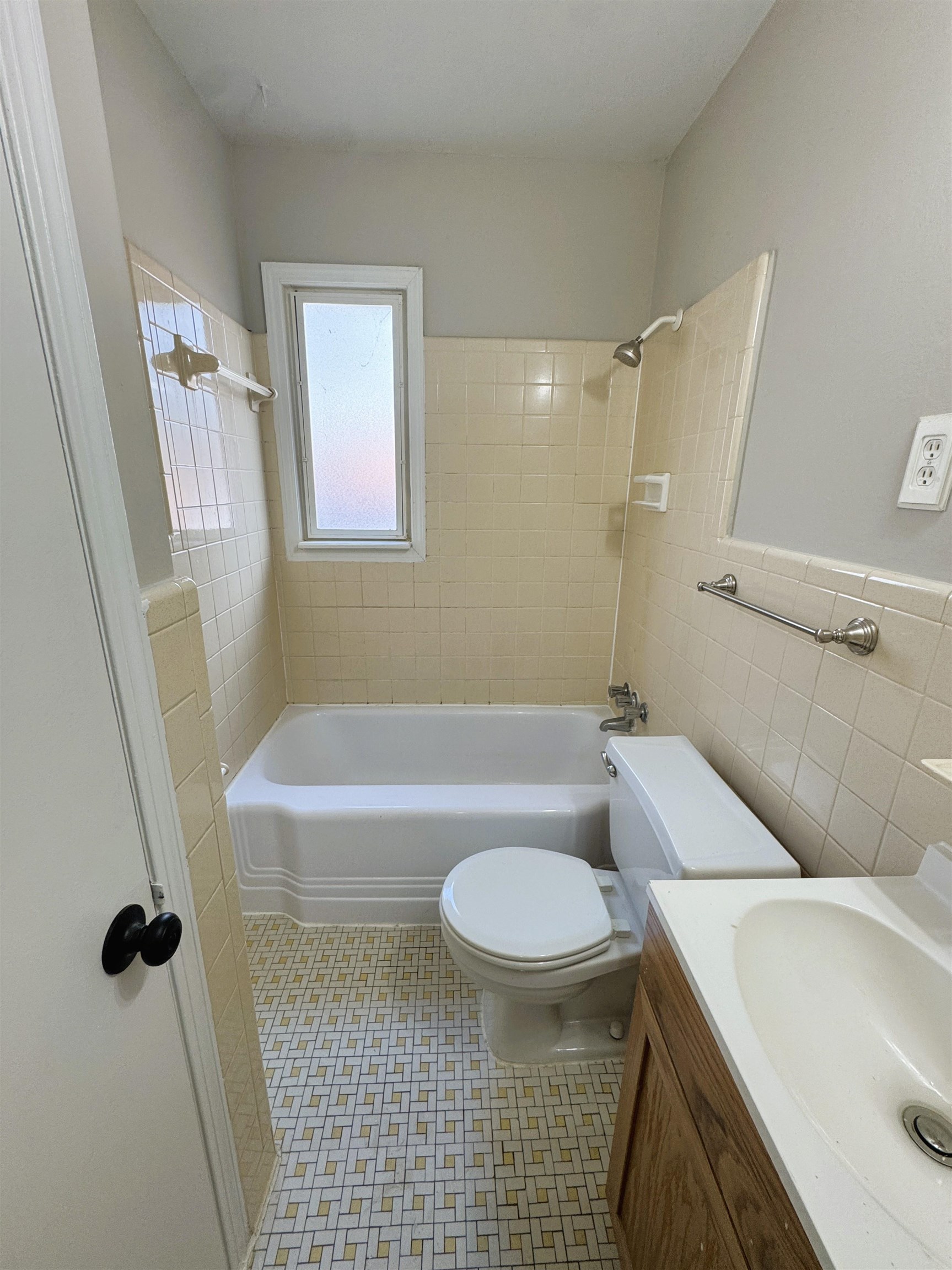 4781 Given Avenue Memphis, TN 38122 - Photo 11 of 15 Bathroom featuring shower combination, tile walls, vanity, and wainscoting