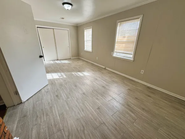 wooden floor in an empty room with a window