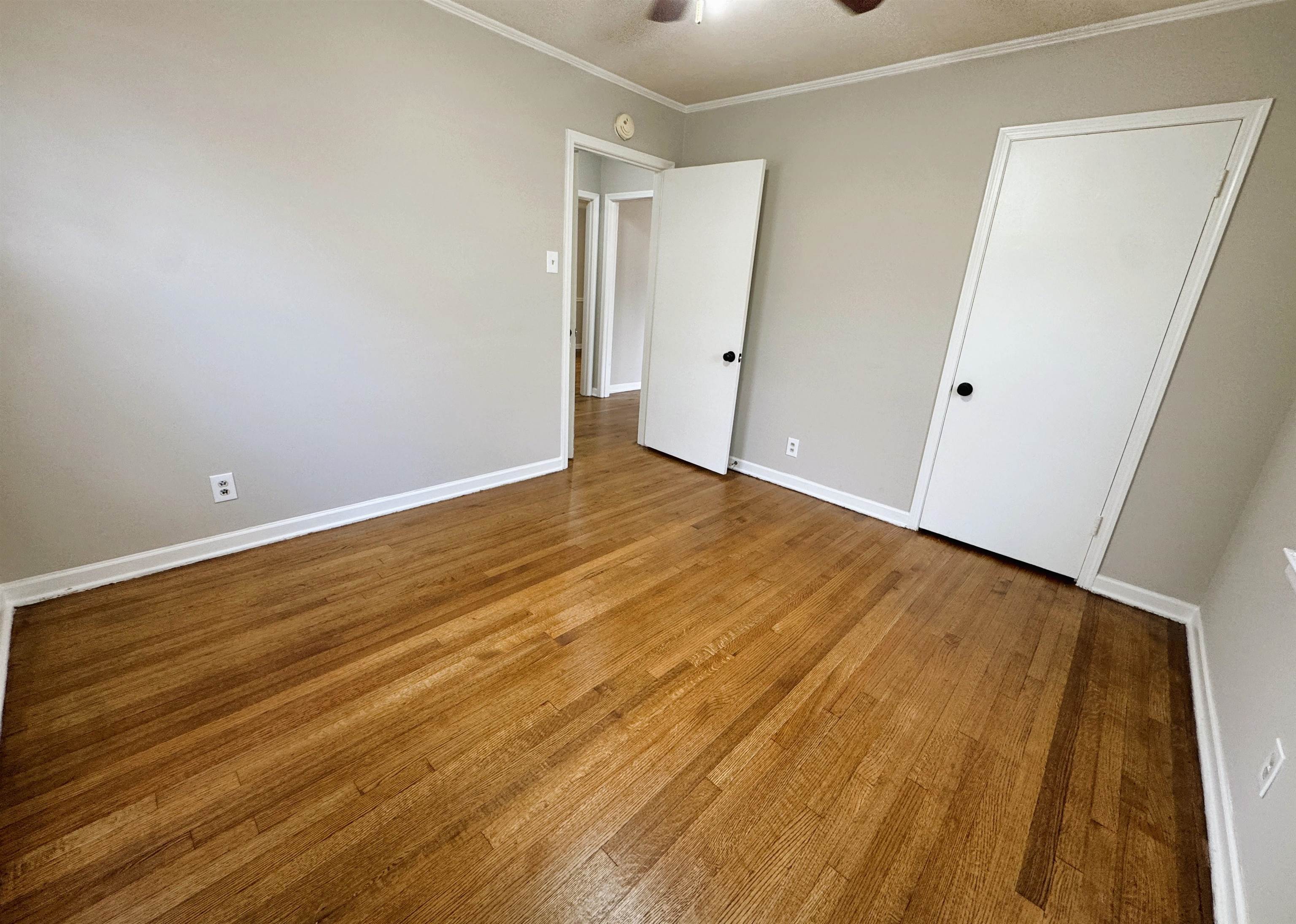 4781 Given Avenue Memphis, TN 38122 - Photo 9 of 15 Unfurnished bedroom featuring light wood-type flooring, crown molding, and a ceiling fan