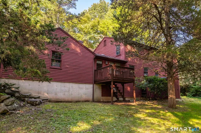 a balcony with wooden fence and trees