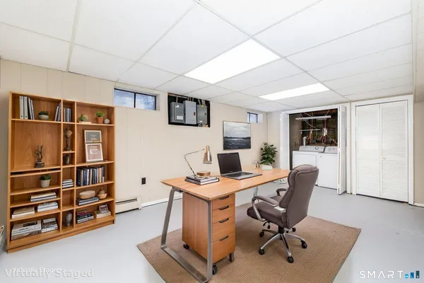 a view of a house with a large tree and a yard