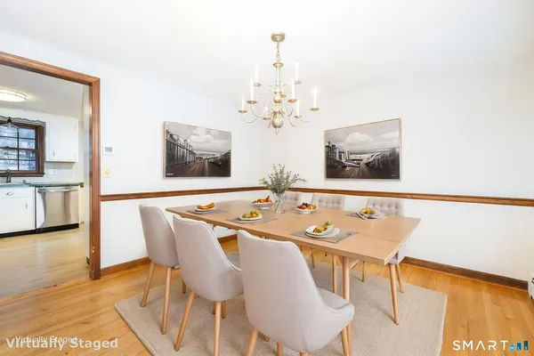 a view of a dining room with furniture and wooden floor