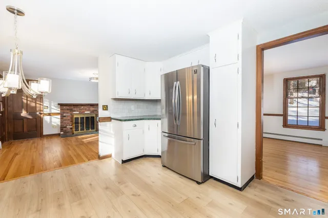 a kitchen with stainless steel appliances granite countertop a refrigerator microwave and stove