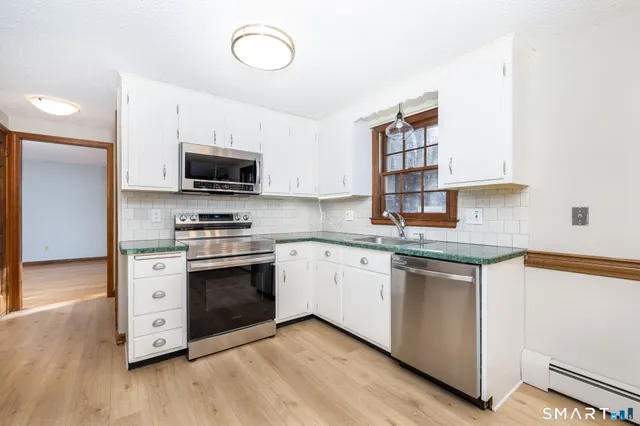 a kitchen with stainless steel appliances granite countertop a stove and a sink