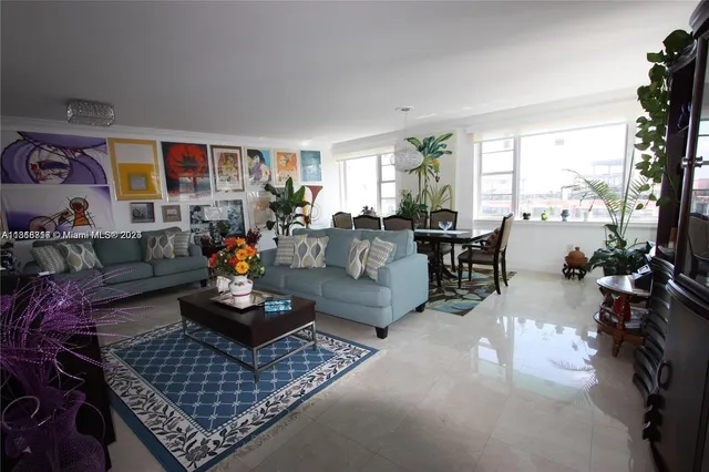 a living room with furniture and a floor to ceiling window