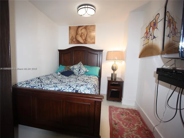 a bedroom with a bed and dresser