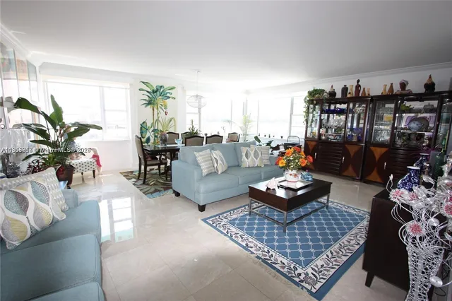 a living room with furniture and a book shelf