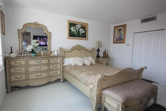 a bedroom with a bed and a dresser