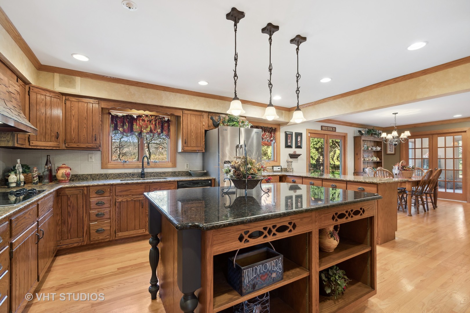 1907 Cherry Valley Road Woodstock, IL 60098 - Photo 4 of 56 a kitchen with stainless steel appliances granite countertop a sink a stove and a wooden floors