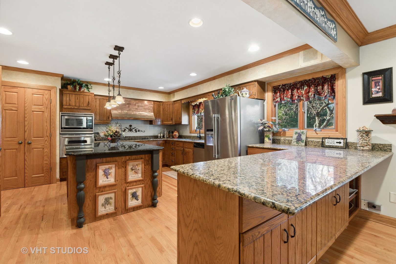 1907 Cherry Valley Road Woodstock, IL 60098 - Photo 5 of 56 a kitchen with stainless steel appliances granite countertop a sink a counter top space and living room view