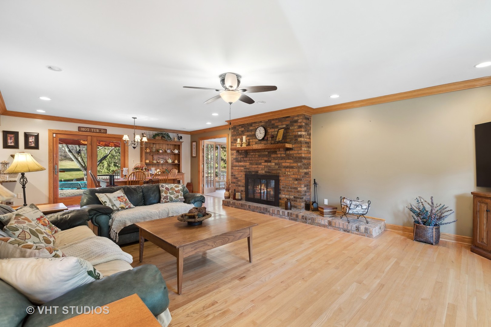 1907 Cherry Valley Road Woodstock, IL 60098 - Photo 7 of 56 a living room with furniture a fireplace and a chandelier