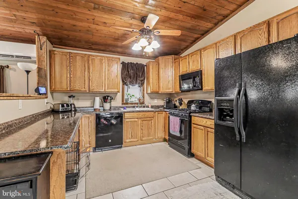 a kitchen with a sink refrigerator and microwave