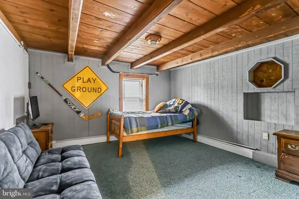 a bedroom with furniture and a window
