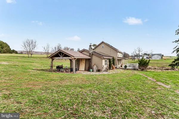 a big house with a big yard and large trees