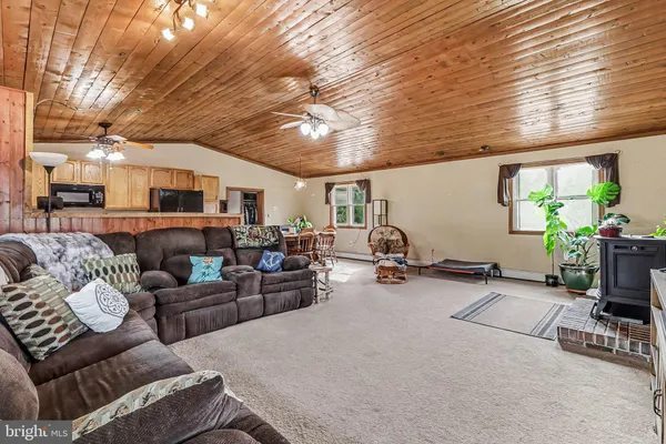 a living room with furniture gym equipment and a large window