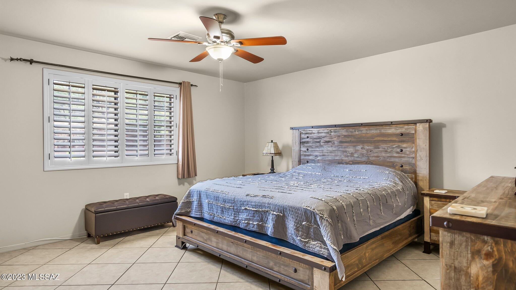 96 Calle Quintana Rio Rico, AZ 85648 - Photo 23 of 30 a bedroom with a bed and a chandelier