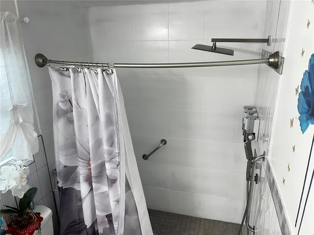 a bathroom with a shower and a tub