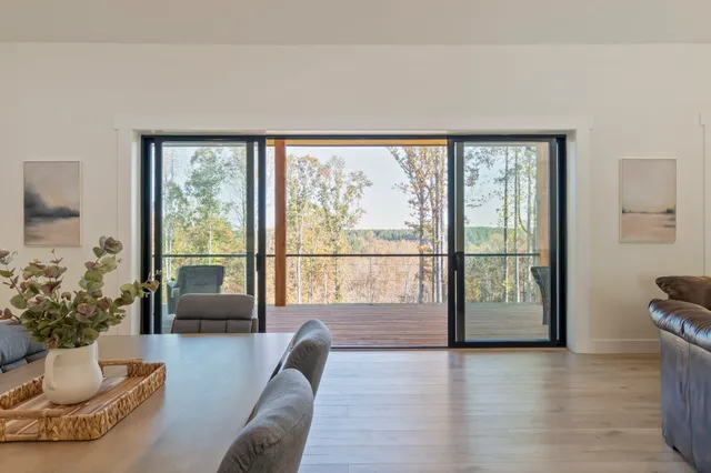 a living room with a bed furniture and a large window