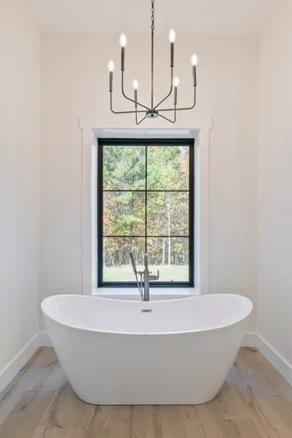 a spacious bedroom with a bed and a flat screen television