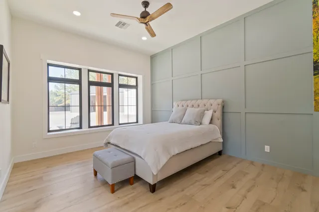 a bedroom with a bed and a flat screen tv
