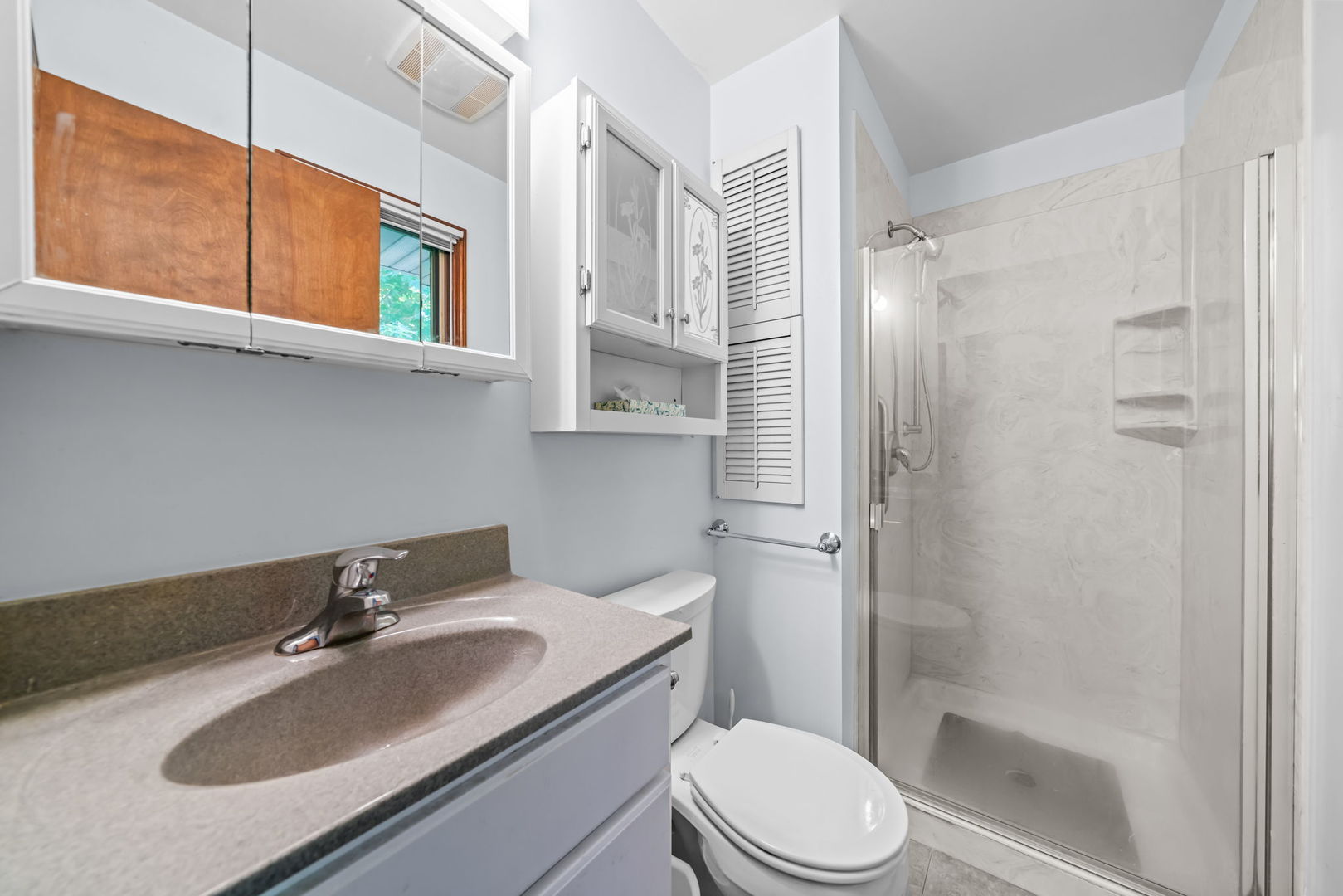 5748 South Skare Road Rochelle, IL 61068 - Photo 17 of 45 a bathroom with a sink toilet and shower