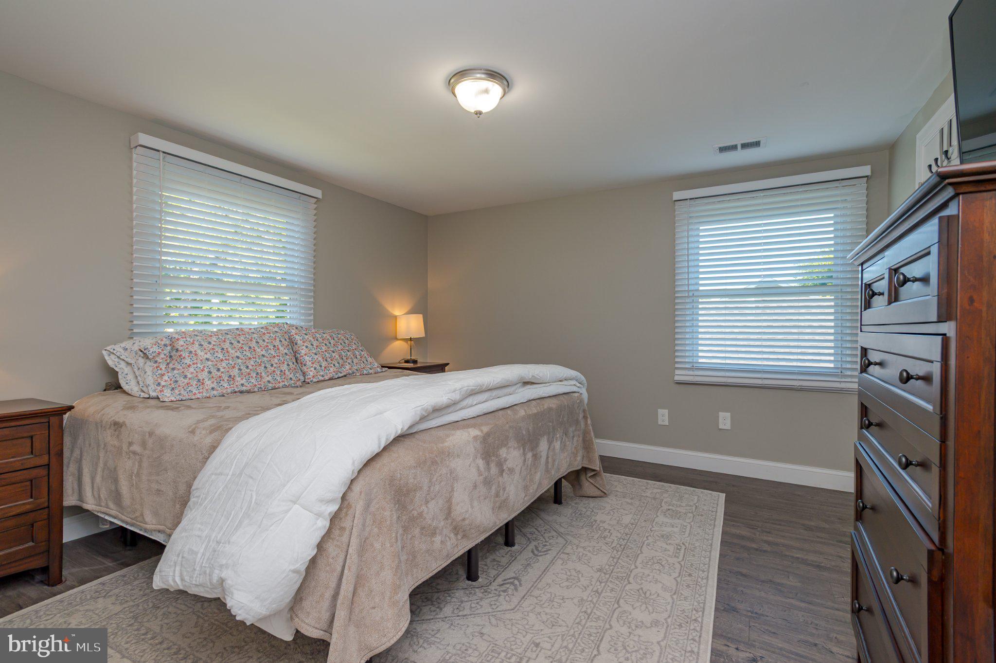 60 Midvale Lane Willingboro, NJ 08046 - Photo 16 of 24 a bedroom with a bed and a flat tv screen on the dresser