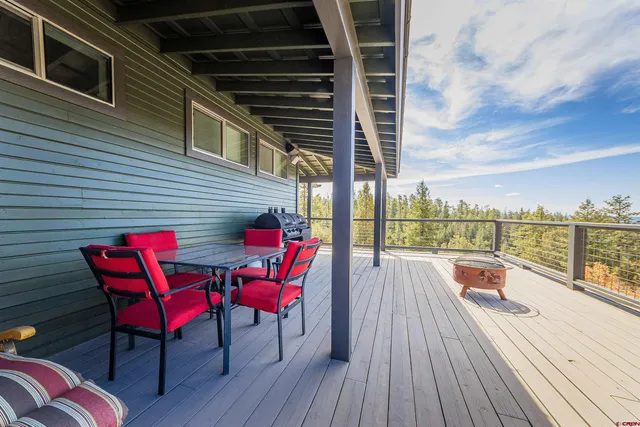 a view of a balcony with chairs and wooden floor