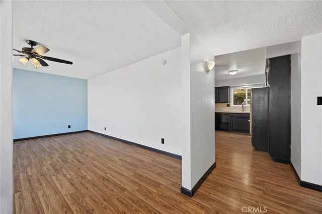 a view of a hallway with wooden floor and closet