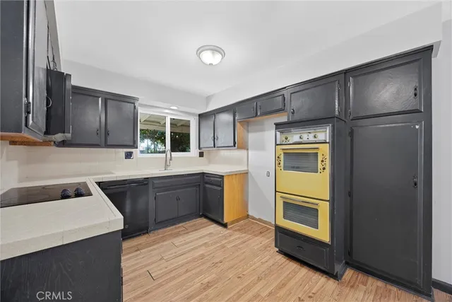 a kitchen with a refrigerator sink and stove