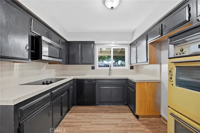 a kitchen with stainless steel appliances granite countertop a sink and stove top oven