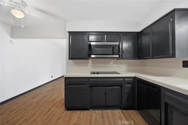 a kitchen with a sink and wooden cabinets