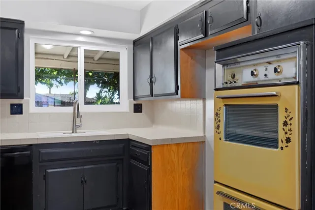 a kitchen with a sink and a refrigerator