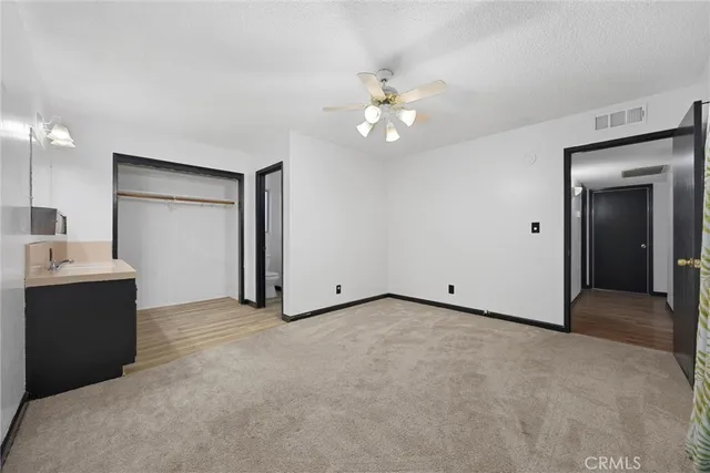 a view of an empty room with a bathroom