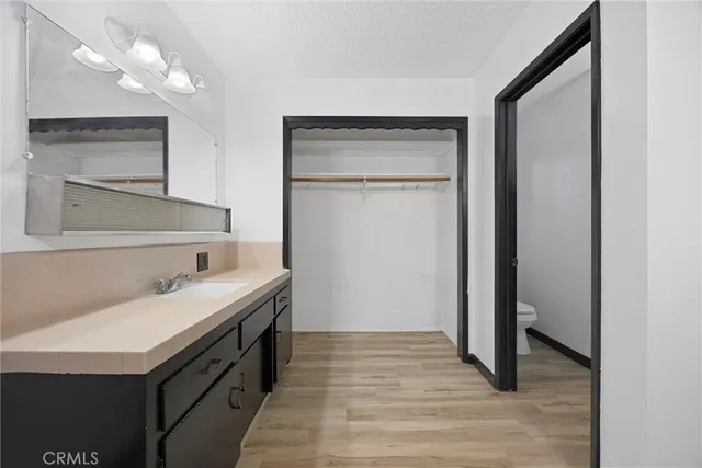 a bathroom with a sink a vanity and a mirror