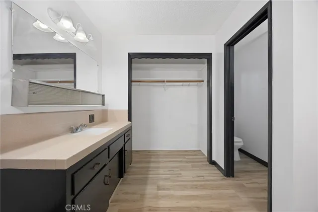 a bathroom with a sink a vanity and a mirror