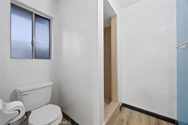 a white toilet sitting next to a small sink