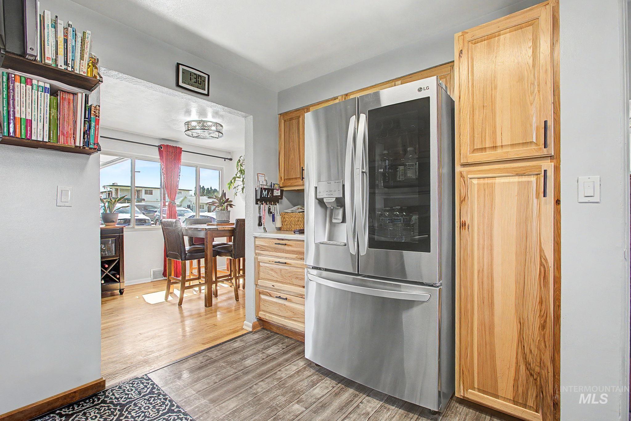 809 Bryden Avenue Lewiston, ID 83501 - Photo 12 of 42 Kitchen with stainless steel fridge, light countertops, light wood-style flooring, and light wood finish cabinets