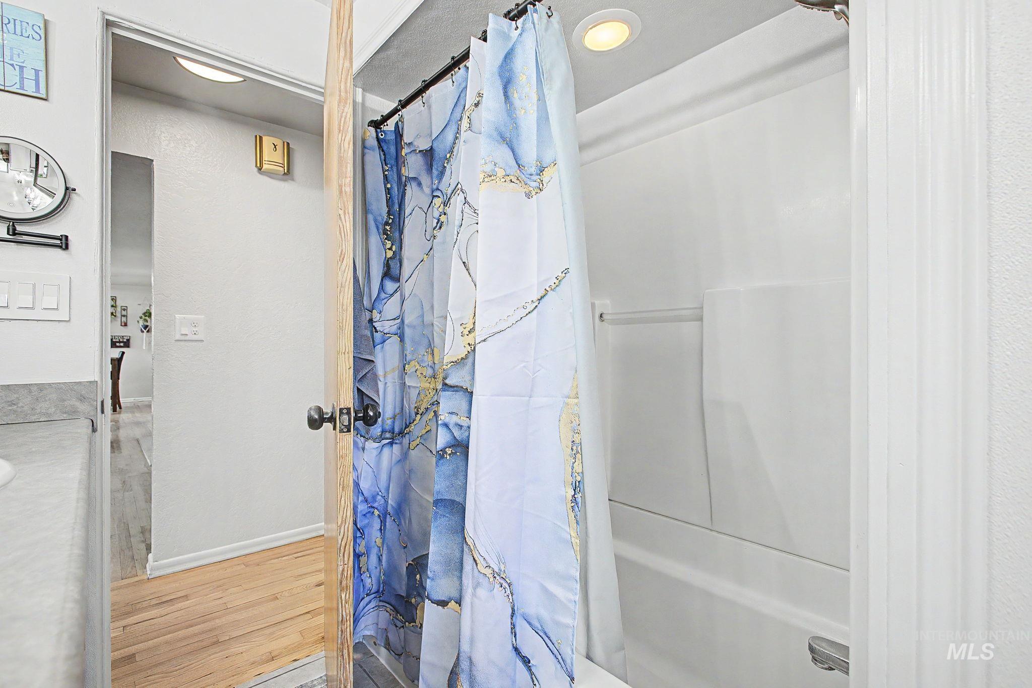 809 Bryden Avenue Lewiston, ID 83501 - Photo 18 of 42 Bathroom with light wood-style floors, curtained shower, and vanity