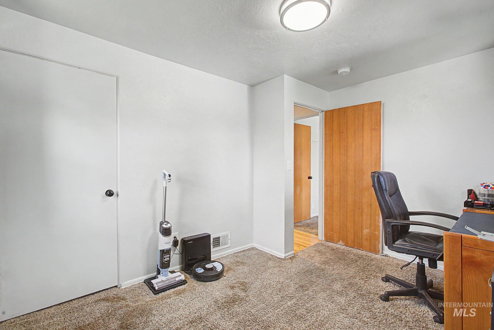 809 Bryden Avenue Lewiston, ID 83501 - Photo 20 of 42 Office space with light carpet and a textured ceiling