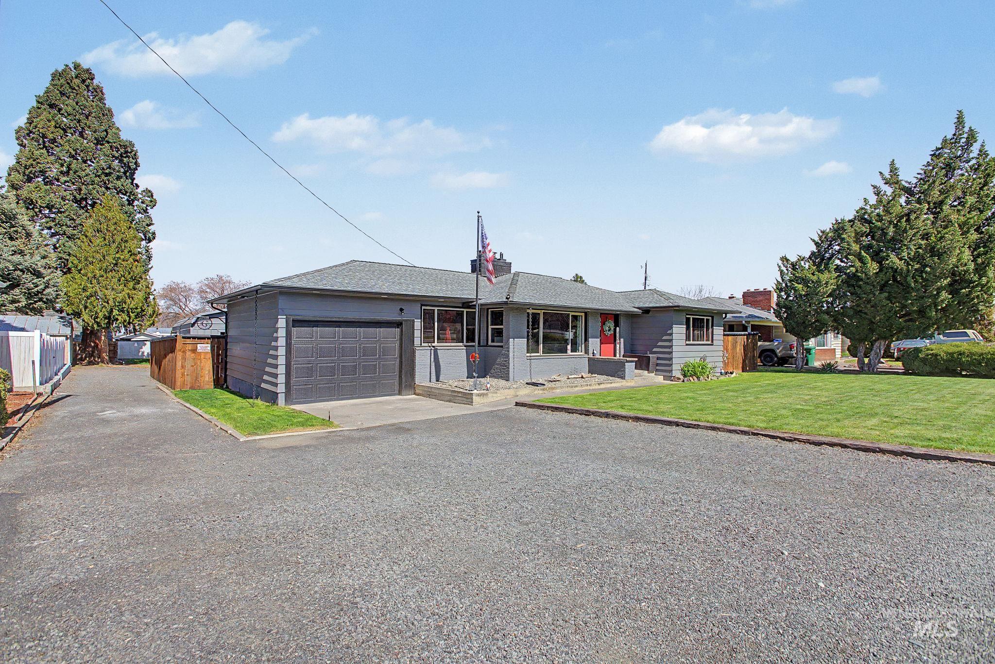 809 Bryden Avenue Lewiston, ID 83501 - Photo 2 of 42 Ranch-style house with an attached garage, driveway, and a shingled roof
