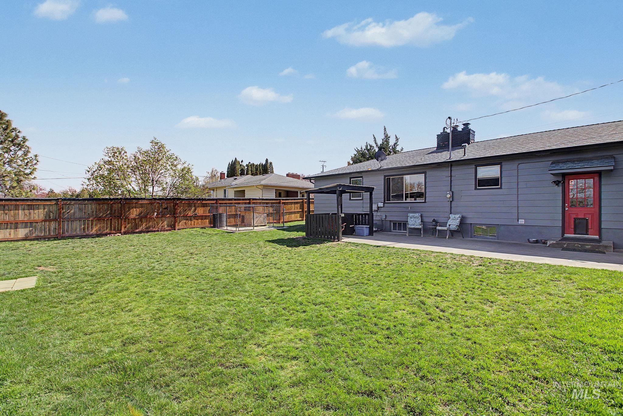 809 Bryden Avenue Lewiston, ID 83501 - Photo 31 of 42 Rear view of house featuring a fenced backyard, a patio, a shingled roof, and a gazebo