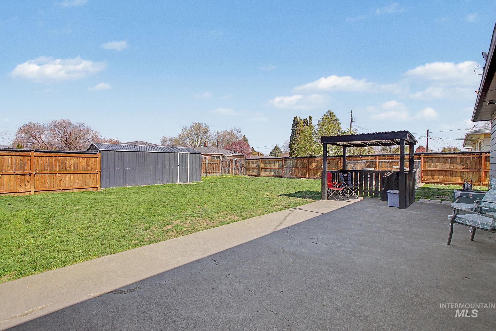 809 Bryden Avenue Lewiston, ID 83501 - Photo 35 of 42 Fenced backyard with a patio, a shed, and a pergola