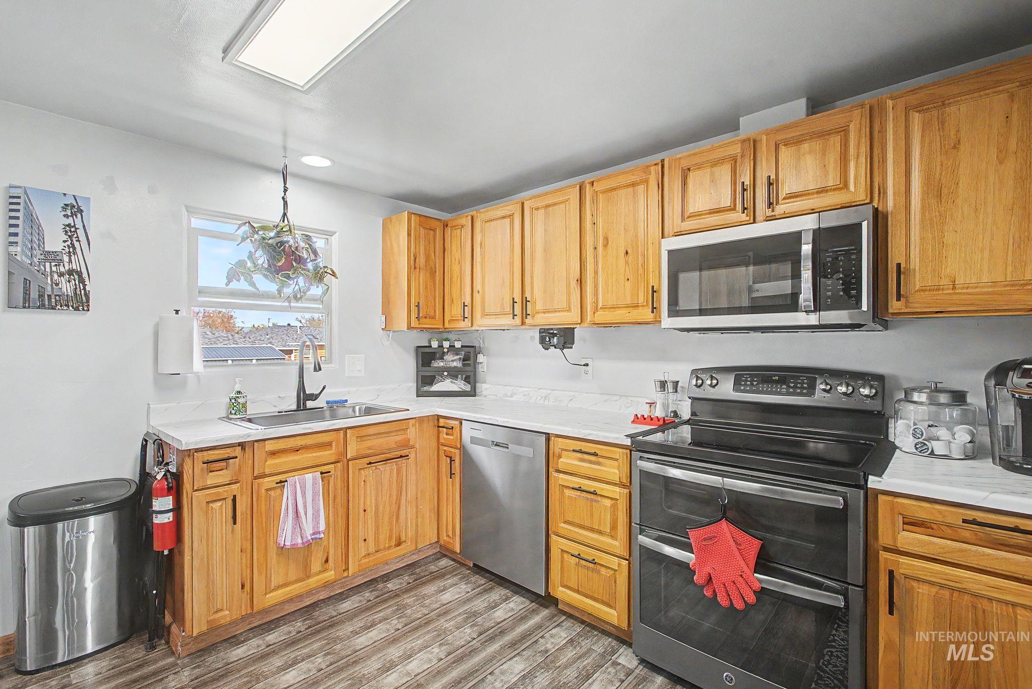 809 Bryden Avenue Lewiston, ID 83501 - Photo 10 of 42 Kitchen with stainless steel appliances, light countertops, wood finished floors, and recessed lighting