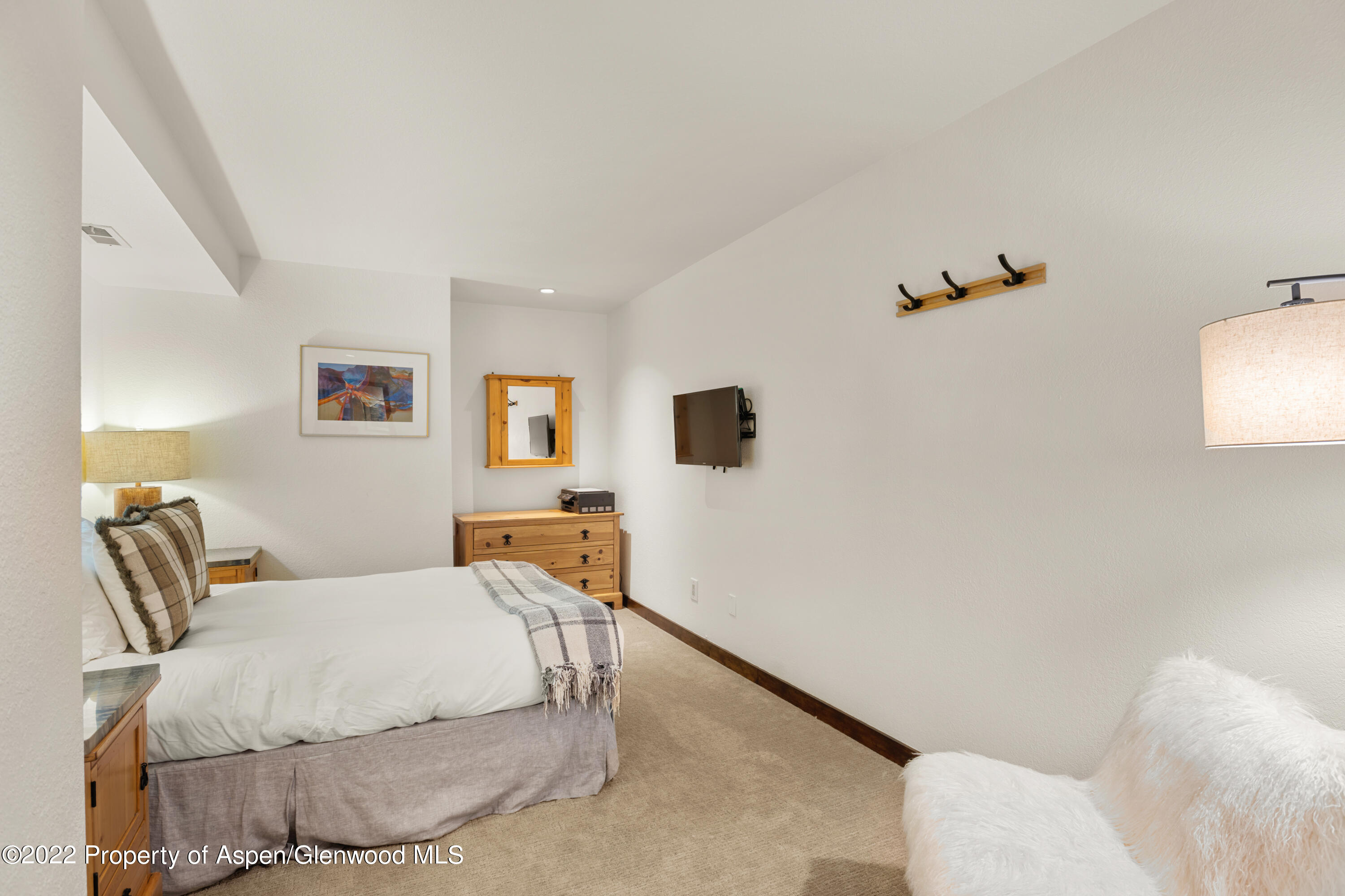 144 Meadow Road Snowmass Village, CO 81615 - Photo 19 of 25 a bedroom with a bed and a flat screen tv