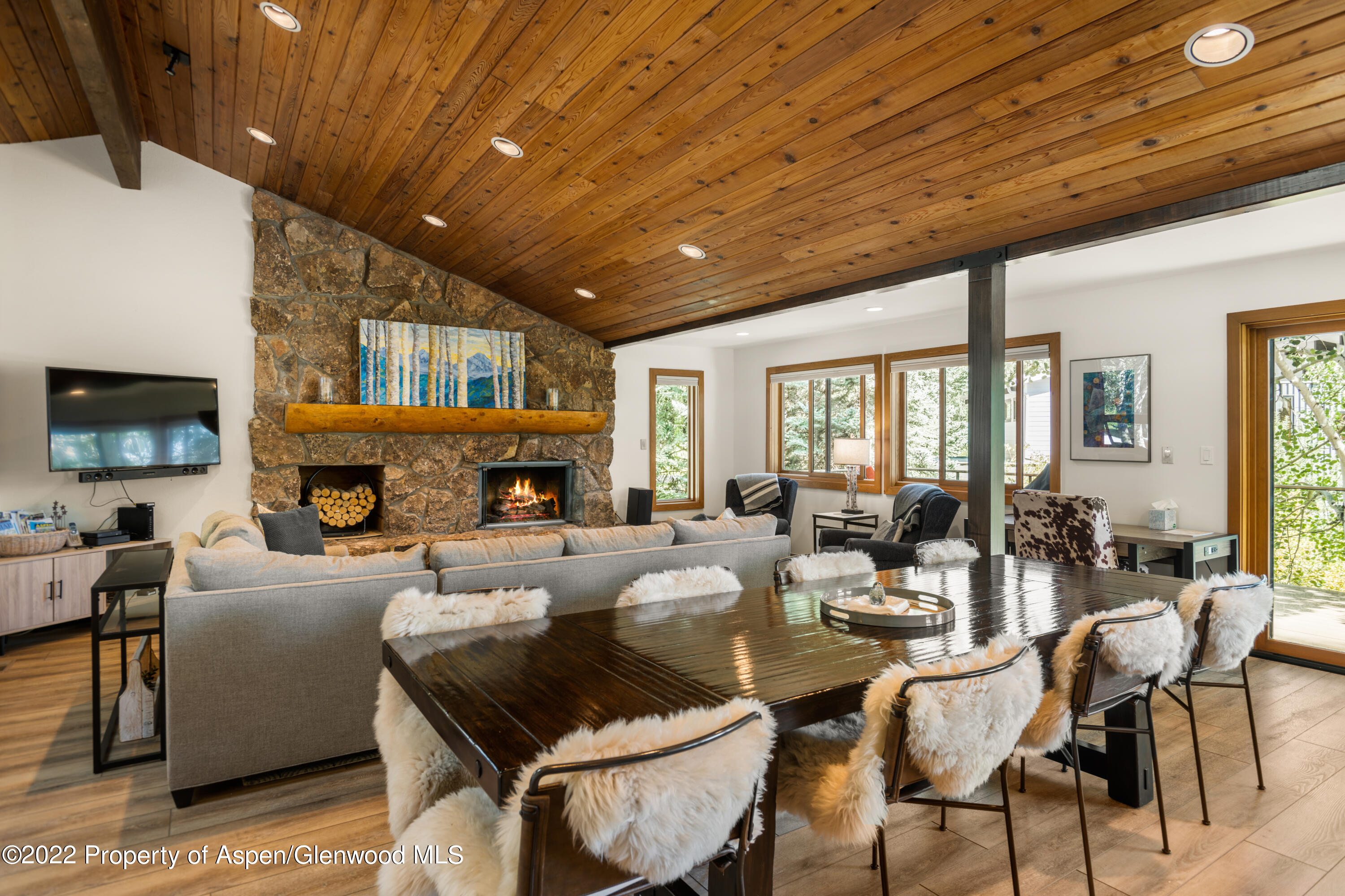 144 Meadow Road Snowmass Village, CO 81615 - Photo 6 of 25 a living room with furniture a fireplace and a wooden floor