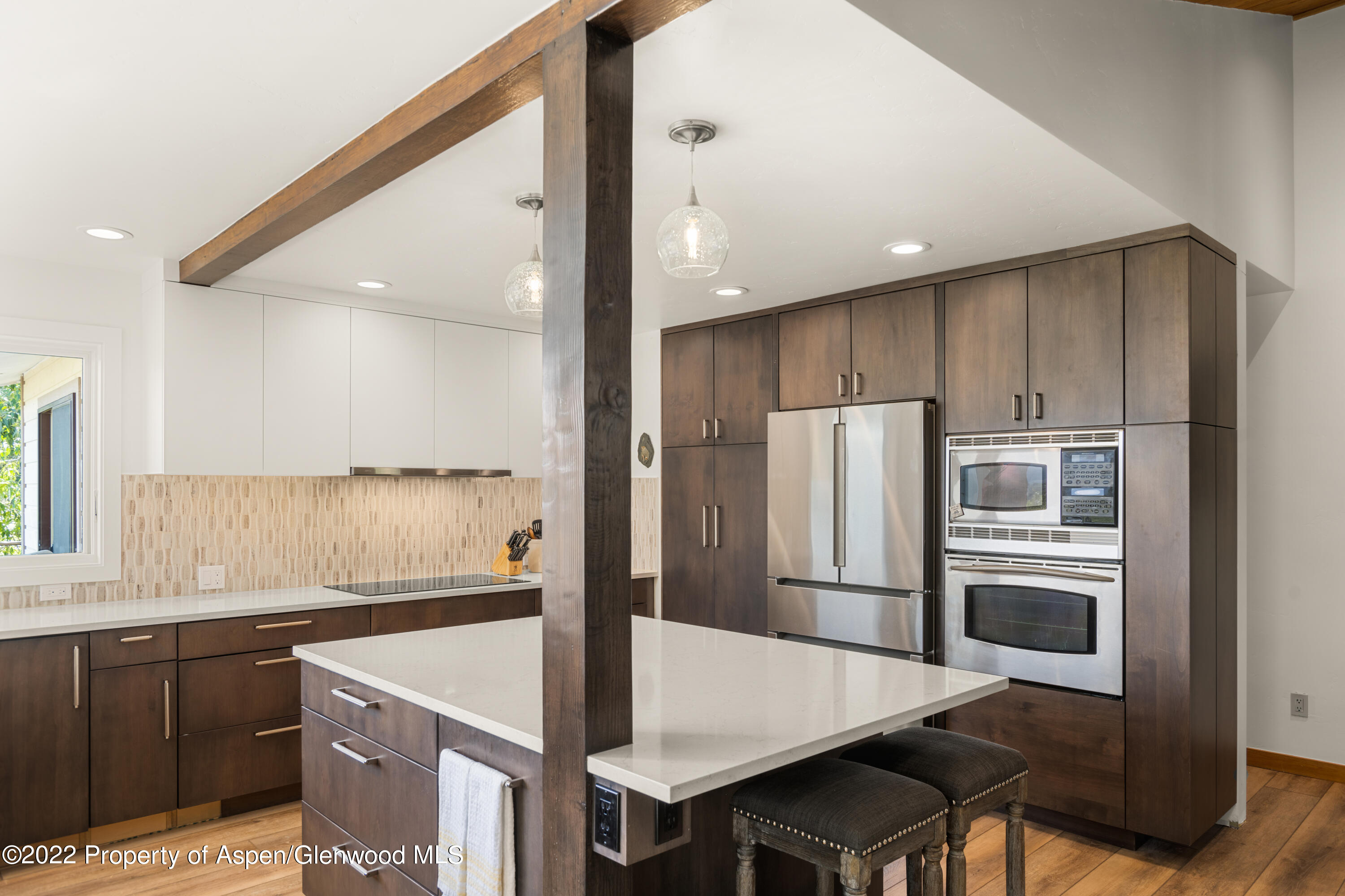 144 Meadow Road Snowmass Village, CO 81615 - Photo 9 of 25 a kitchen with a refrigerator a sink and a stove