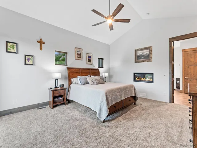 a bedroom with a large bed and a chandelier