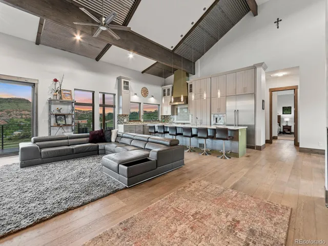 a living room with furniture and kitchen view